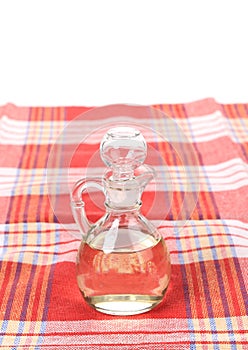Vinegar in glass carafe on table.