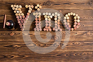 Vino cork letters with bottle of wine on wood