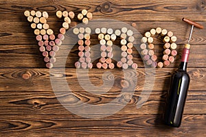 Vino lettering made of corks with bottle of wine