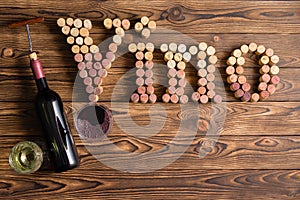 Vino lettering made of corks on wooden background photo