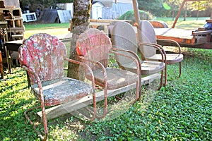 Vinrtage Red Metal Chairs Lined Up at Antique Salvage Yard