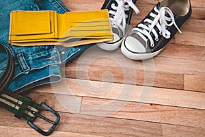 Vintag jean,cloths and accessories on a wooden background photo