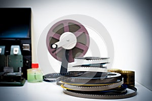 A vintage 8mm movie editing desktop with reels and elements in o