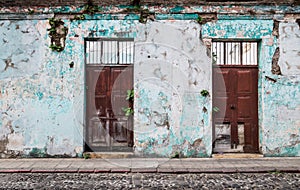 Vintage abandoned colonial building with plants growing out of the cracked walls, Antigua, Guatemala