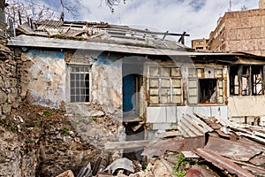 A vintage abandoned house with decayed and wrecked walls