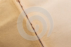 Vintage abstract background texture of shabby yellowed brown cardboard paper with damaged binding of old stained book with copy