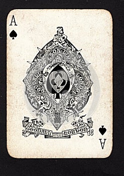A vintage ace of spades playing card on a black background.