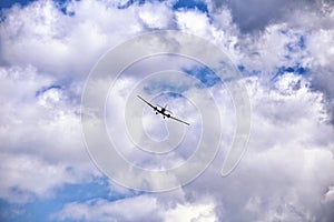 Vintage aircraft coming towards the camera on the sky