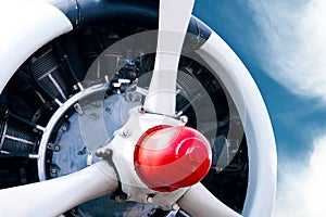 Vintage airplane propeller with radial engine on a beautiful blue sky