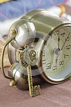 Vintage alarm clock and old key