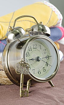 Vintage alarm clock and old key