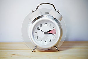 Vintage alarm clock showing change from daylight saving time and fall back to standard time, copy space