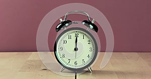 Vintage alarm clock is showing midday or midnight movement. It is twelve o`clock, holiday happy new year festive and christmas