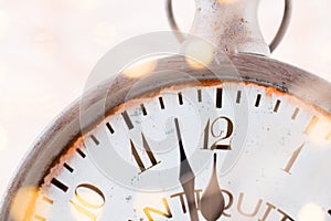 Vintage alarm clock is showing midnight. It is twelve o`clock, c