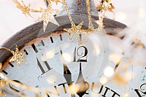 Vintage alarm clock is showing midnight. It is twelve o`clock, christmas and bokeh, holiday happy new year festive concept on