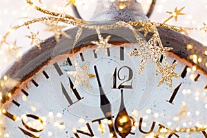 Vintage alarm clock is showing midnight. It is twelve o`clock, christmas and bokeh, holiday happy new year festive concept on