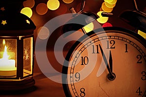 Vintage alarm clock is showing midnight. It is twelve o`clock, christmas and bokeh, holiday happy new year festive concept