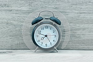 Vintage alarm clock on wooden floor