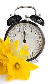 Vintage clock, yellow daffodils, spring, dst. photo