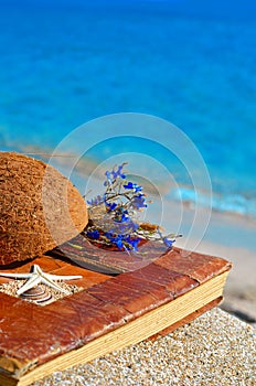 Vintage album on the sand with coconut shell