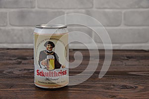 A vintage aluminium can of Schultheiss beer against the brick wall