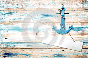 Vintage anchor on old wooden background with blue paint