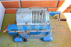 Vintage antique arithmometer named Felix. Old retro blue calculator.