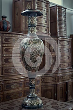 Vintage antique asian vase on a wooden table