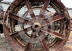 Vintage antique automotive tractor steel wheel spokes covered in rust and oxidation