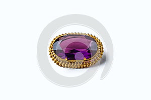 Vintage antique brooch with a large semi-precious purple stone on white background. Oldfashioned decoration from grandma`s jewelr photo