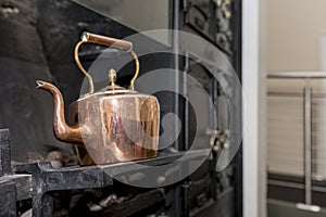 Vintage and antique copper kettle on a Victorian stove in a trad