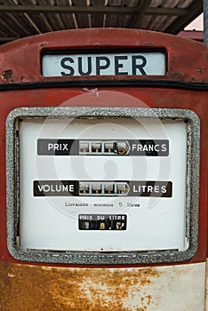 A vintage antique Gasoline fuel pump on red