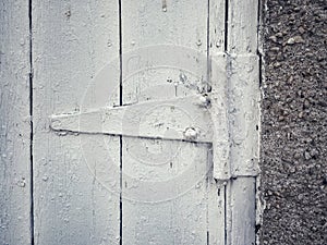 Black and white photography featuring an old hinge on a barndoor. photo