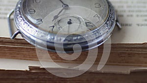 Vintage antique pocket watch on the background of old books