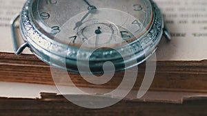 Vintage Antique pocket watch on the background of old books