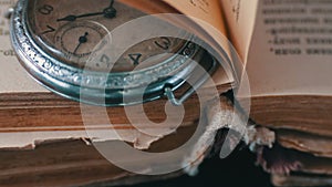 Vintage Antique pocket watch on the background of old books.