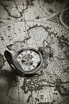 Vintage antique pocket watch on old map background