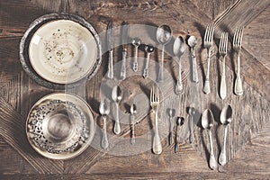 Vintage antique silverware on wooden background