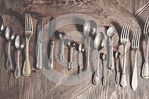 Vintage antique silverware on wooden background