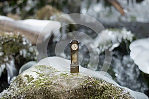 Vintage antique standing clock by the riverside