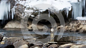 Vintage antique standing clock by the riverside