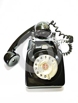 A vintage and antique telephone with white background. photo