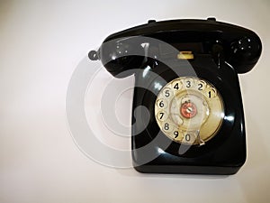 A vintage and antique telephone with white background. photo