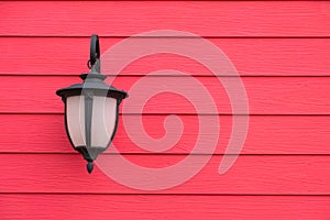 Vintage Antique wall lamp on red wood wall, for background with