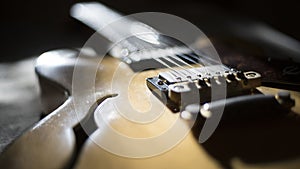 Vintage archtop guitar in natural maple close-up back light high angle view
