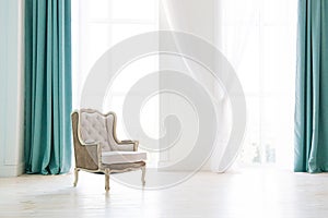 Vintage armchair against white wall and big window with curtain. Space for your copy