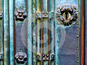 vintage, artistic tarnished green copper color plated door lock detail with ornate keyhole.