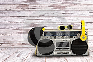 Vintage audio player with headphones.fashionable cap and sunglasses.Vintage style .The concept of the music Hip hop style.