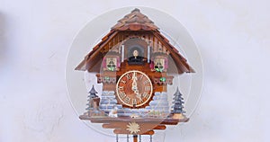 Vintage authentic wooden cuckoo clock is striking the hours with sound and automated cuckoo bird that moves with each