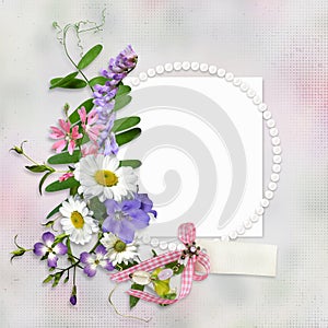 Vintage background with frame for photo or text and a bouquet of summer meadow flowers